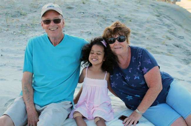 Bill Ludwig, CAR T clinical trial participant, with his wife Darla and granddaughter at the beach